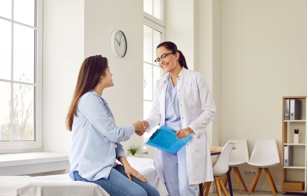 Portrait,of,smiling,friendly,female,doctor,therapist,shaking,hands,with